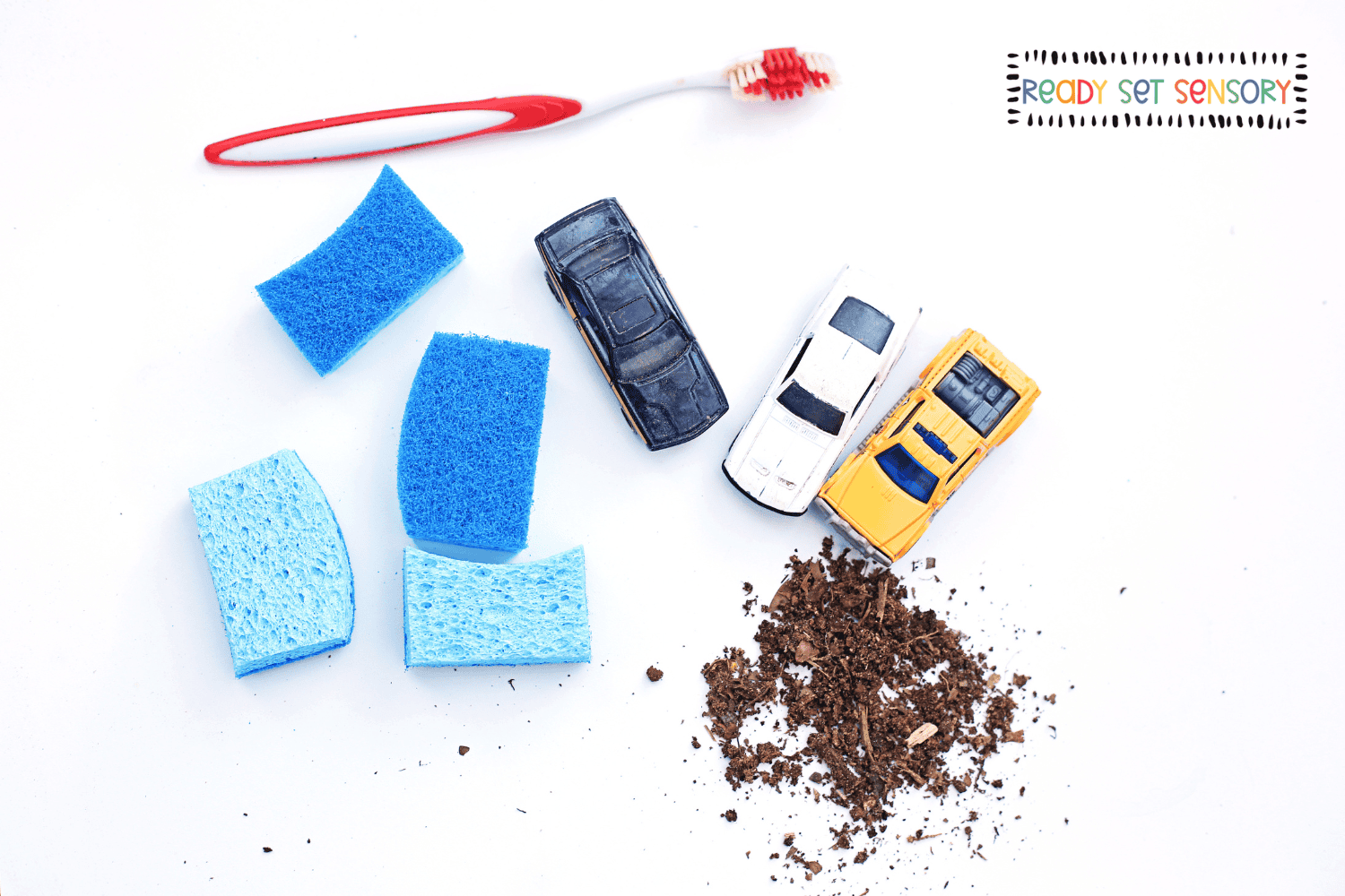 Car wash sensory bin supplies with toy cars and sponges