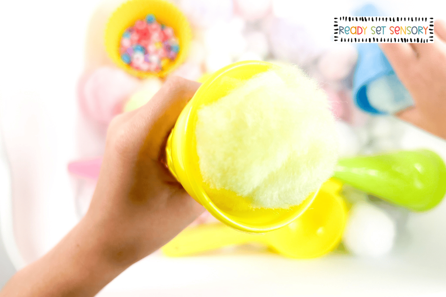 Close-up of pom pom ice cream scoops in a sensory play activity