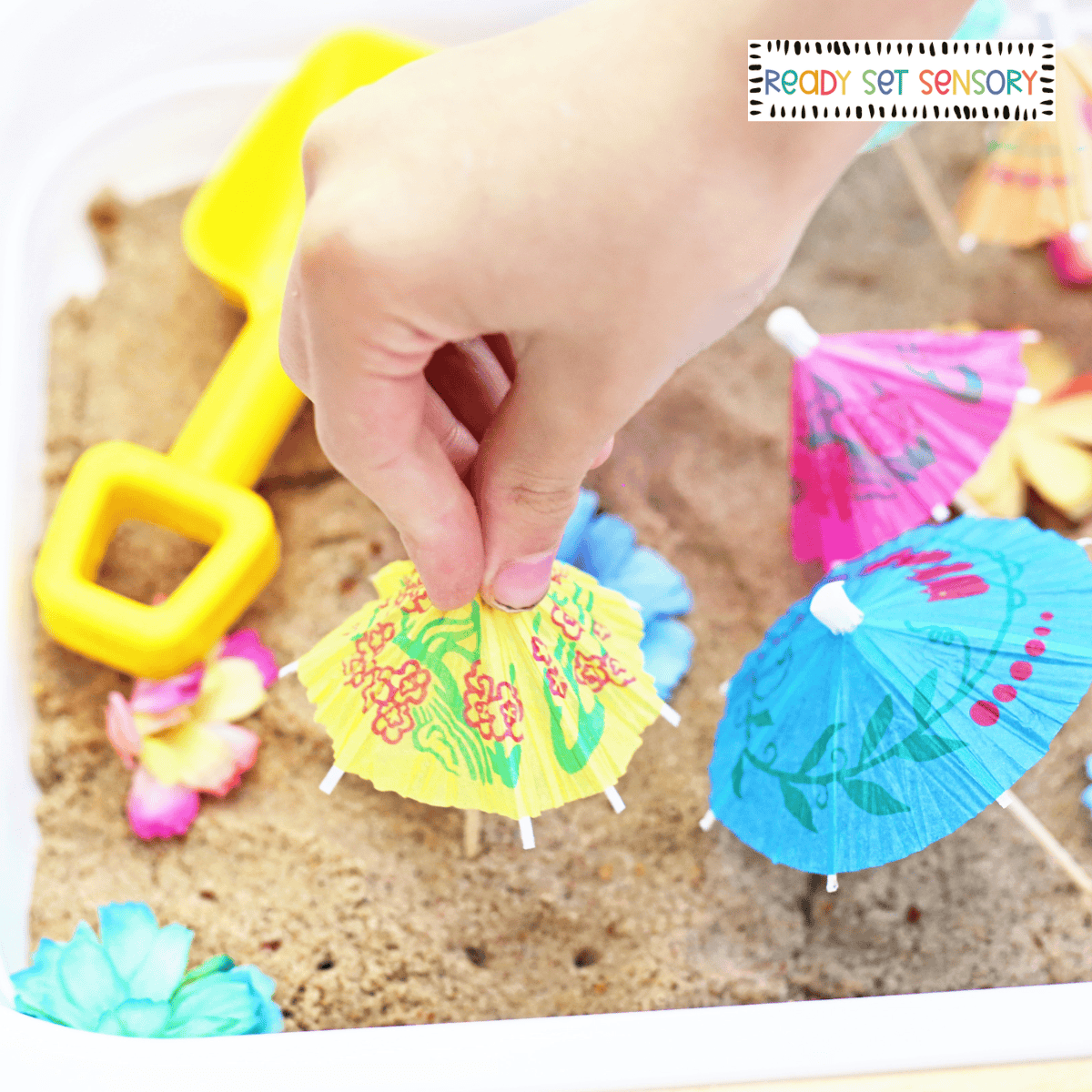Tropical sensory bin activity with sand, flowers, and gems