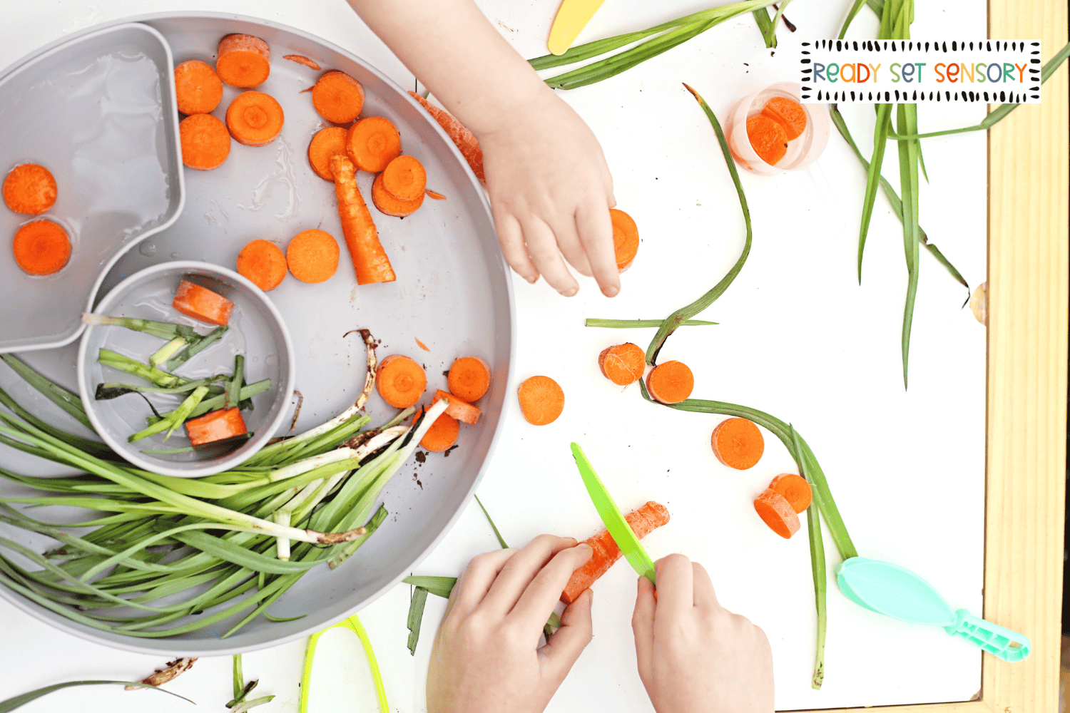 Toddler exploring Bunny Bait sensory bin with real carrots and scoops