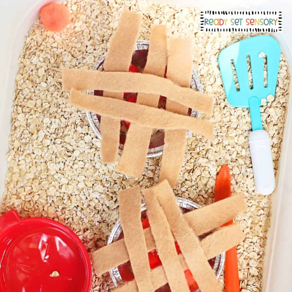 Fall Pie Shop Sensory Bin With Oats and Pom Poms